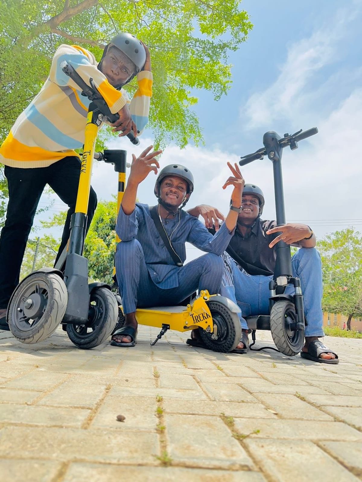 Trekk Mobility riders posing with their branded electric scooters