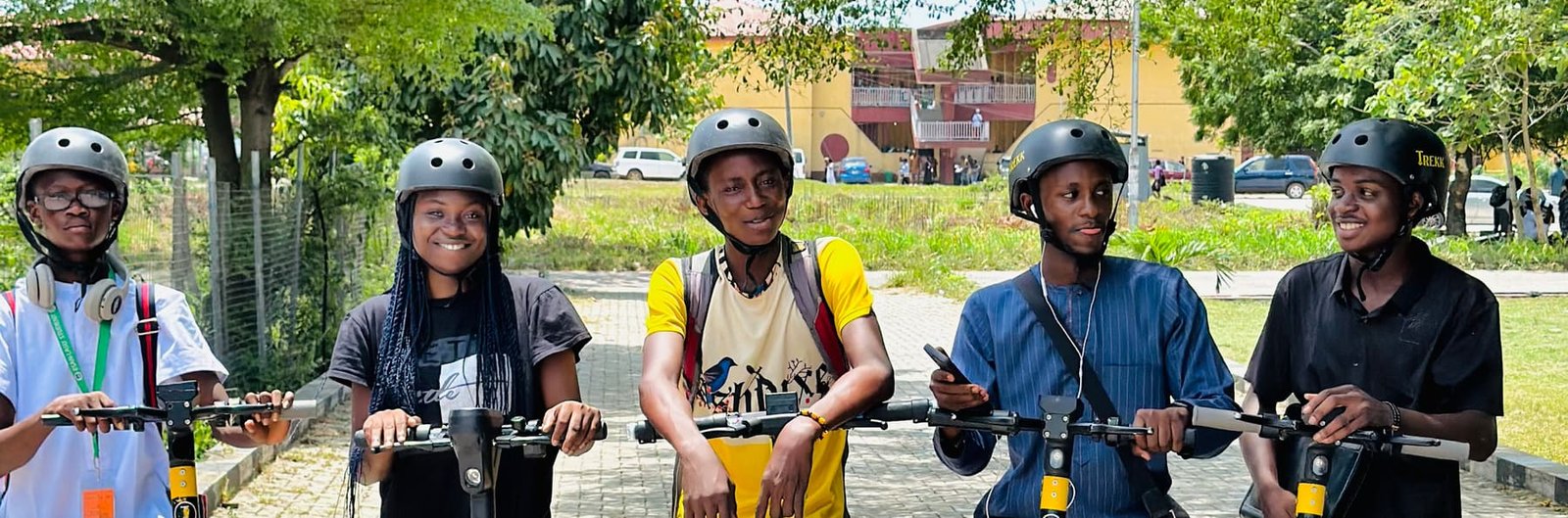 Trekk Mobility riders with their electric scooters on a Nigerian university campus